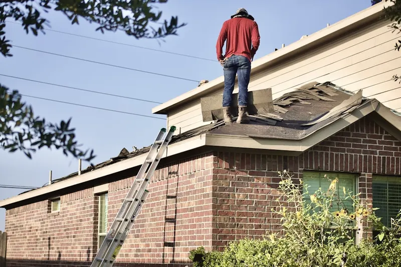 Professional roofer working on a residential roof in Center Moriches